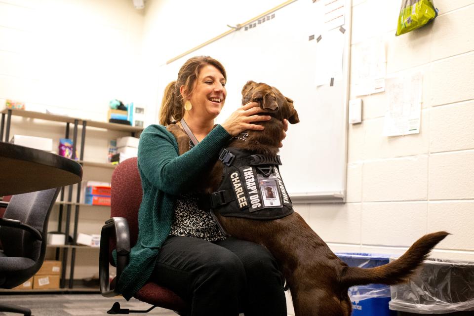 Dickinson Elementary School counselor Brandi Knott pets, Unified School District of De Pere's first elementary school therapy dog, Charlee on Oct. 4 at Dickinson Elementary School in De Pere. Samantha Madar/USA TODAY NETWORK-Wisconsin