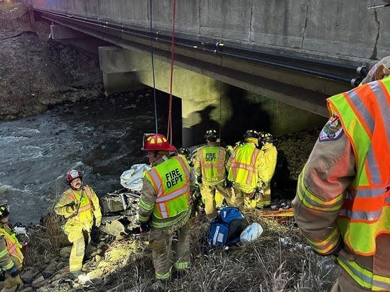 Officials rescue a man from a crashed car in Portage, Indiana.