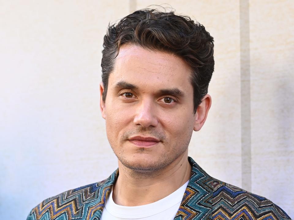 John Mayer poses on the red carpet.