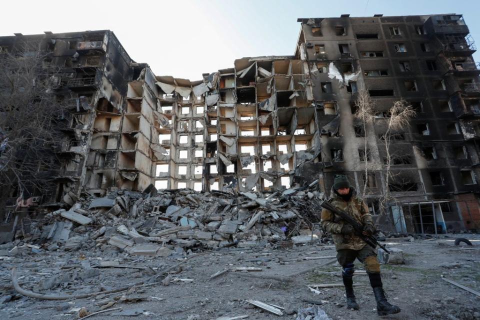 A pro-Russian soldier next to a destroyed building in Mariupol (REUTERS)