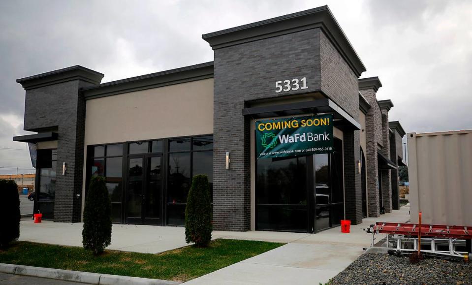 Signs displayed on the the building at 5331 W. Canal Dr. advertise it as a new location of a WaFd Bank to be opening soon. The building, formerly one of two TeaHaus locations, is currently being remodeled.