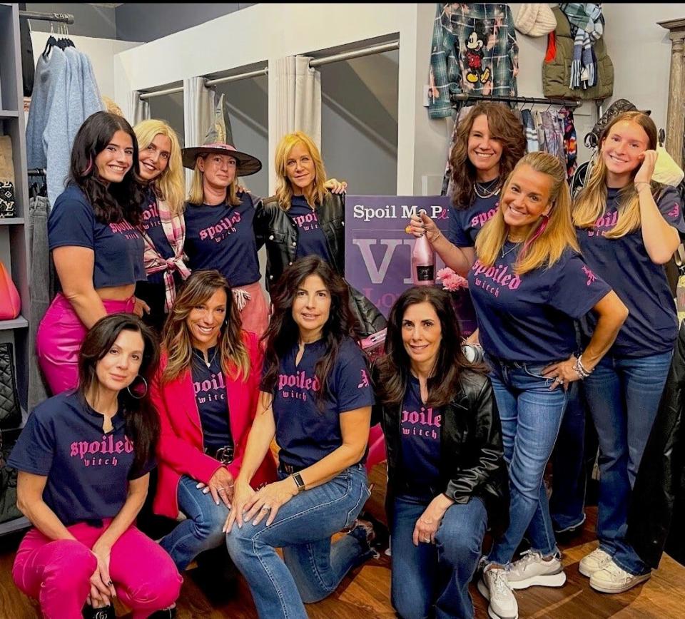The staff at Threads, a clothing store in Westwood, prepare for the Pink Witches Night Out, which helps raises money for breast cancer patients.