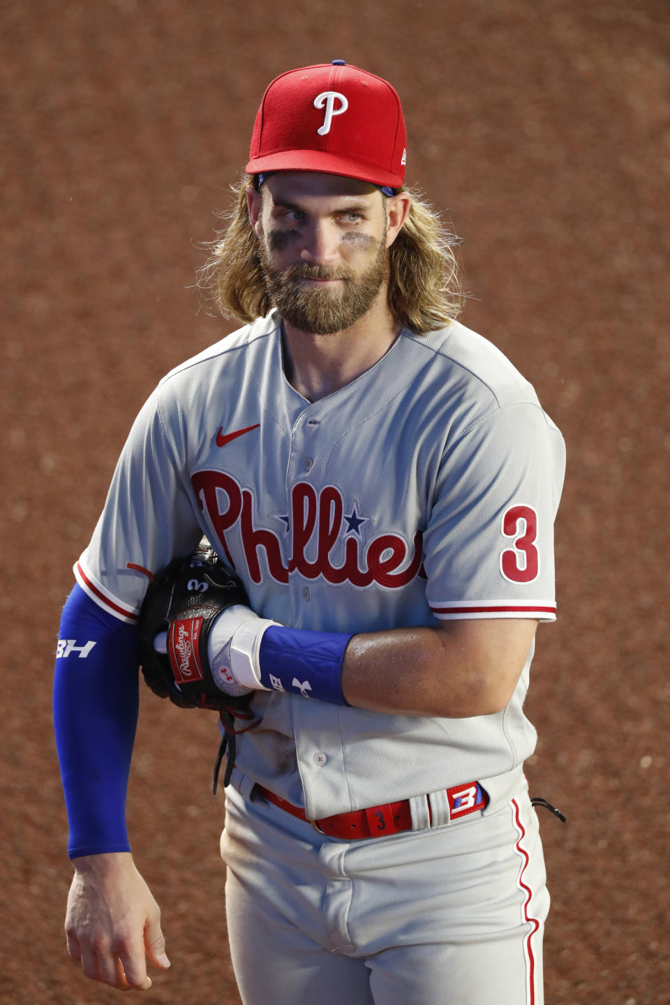 Philadelphia Phillies right fielder Bryce Harper pauses as a baseball game against the New York Yankees is halted shortly before it went into a rain delay during the seventh inning Monday, Aug. 3, 2020, at Yankee Stadium in New York. (AP Photo/Kathy Willens)