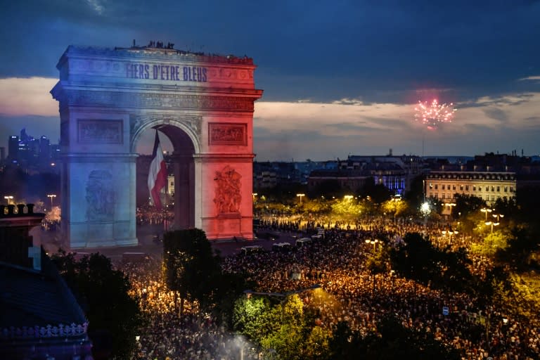 The Arc de Triomphe in Paris is lit up with the blue, white and red of the French flag