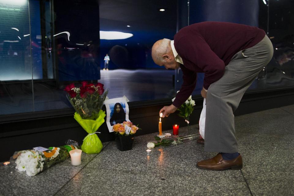 A man lights a candle outside the Atocha Bombing Memorial, in Madrid, Spain, Tuesday March 11, 2014, in remembrance of those killed and injured in the Madrid train bombings marking the 10th anniversary of Europe's worst Islamic terror attack. The attackers targeted four commuter trains with 10 shrapnel-filled bombs concealed in backpacks during morning rush hour on March 11, 2004. (AP Photo/Andres Kudacki)