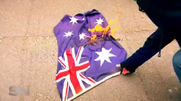 At a rally attended by Sunday Night the Australian flag was set alight