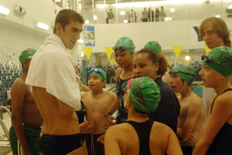 Olympic swim champ Michael Phelps talks with children at a YMCA in New York City on August 28, 2008. On June 6, 1844, the Young Men's Christian Association -- YMCA -- was founded in London. File Photo by Ezio Petersen/UPI