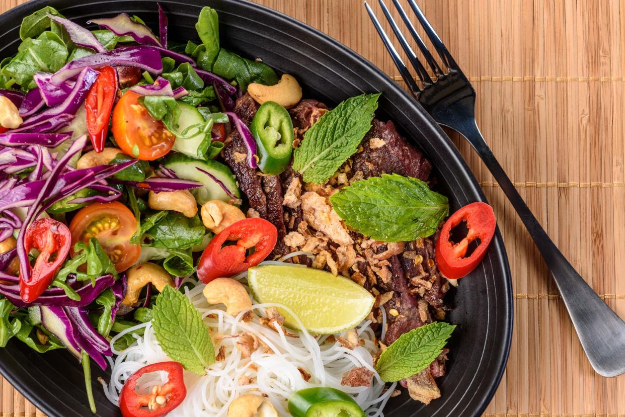 A serving of beef noodle salad, with spicy fresh ingredients for Asian fusion inspired meal