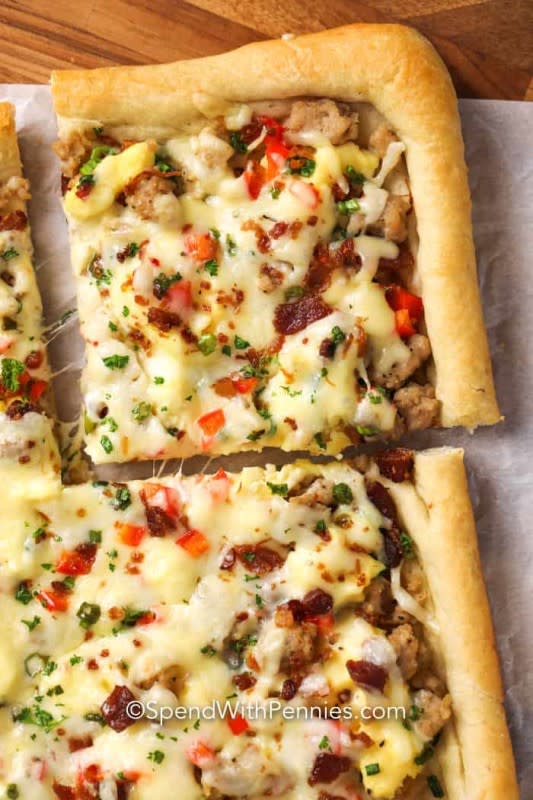 <p>Spend With Pennies</p><p>This pizza is piled high with our favorite breakfast toppings including sausage, bacon, green onions, eggs and of course heaps of cheese. Consider the best grab-and-go breakfast that will bring everyone to the table!</p><p><strong>Get the recipe: <a href="https://www.spendwithpennies.com/cheesy-breakfast-pizza/" rel="nofollow noopener" target="_blank" data-ylk="slk:Cheesy Breakfast Pizza;elm:context_link;itc:0;sec:content-canvas" class="link ">Cheesy Breakfast Pizza</a></strong></p>