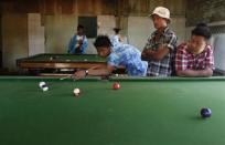 Young men play billiard in Kawhmu township, February 8, 2012.