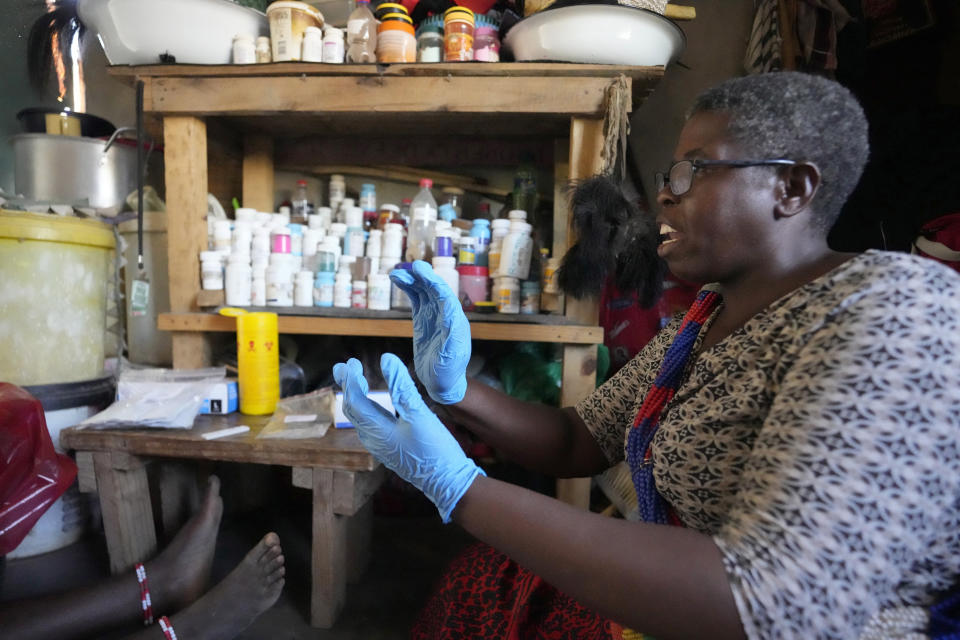 La curandera Florence Khoza habla con un paciente antes de realizarle un test rápido de VIH en sangre, en Bushbuckridge, Sudáfrica, el 9 de mayo de 2024. (AP Foto/Themba Hadebe)