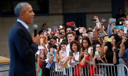 U.S. President Barack Obama speaks to an overflow crowd outside a rally in support of Hillary Clinton's campaign in Las Vegas, Nevada, U.S. on October 23, 2016. REUTERS/Kevin Lamarque/File Photo