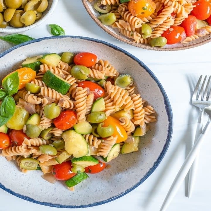 A plate of pasta and colorful veggies