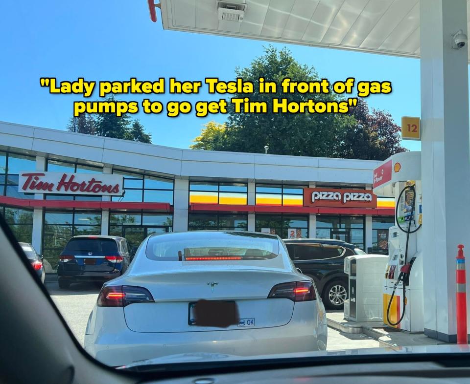 View from a vehicle waiting in line at a gas station with an attached Tim Hortons and Pizza Pizza on a sunny day