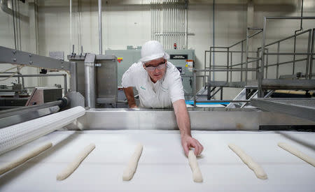 An employee checks on a dough during the production process at the Gonnella Baking Company in Aurora, Illinois, U.S., November 16, 2017. Picture taken November 16, 2017. REUTERS/Kamil Krzaczynski