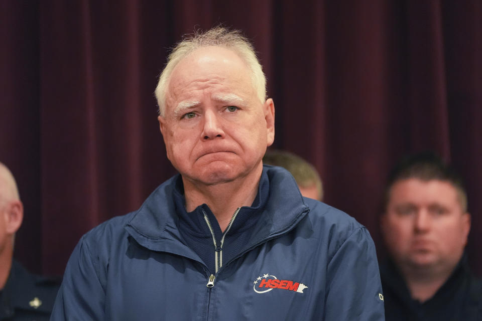 Minnesota Gov. Tim Walz stands at a press conference after two police officers and a first responder were shot and killed Sunday, Feb. 18, 2024, in Burnsville, Minn. (AP Photo/Abbie Parr)