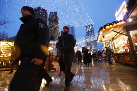 Police patrol at the re-opened Christmas market at Breitscheid square. REUTERS/Fabrizio Bensch