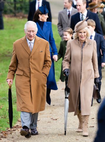 <p>Samir Hussein/WireImage</p> King Charles and Queen Camilla attend Christmas 2023