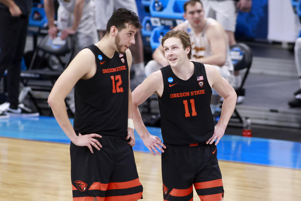 Roman Silva (L) and Zach Reichle of Oregon State talk on the court during their win over Loyola Chicago in the 2021 NCAA men's basketball tournament on March 27. (Justin Casterline/Getty Images)