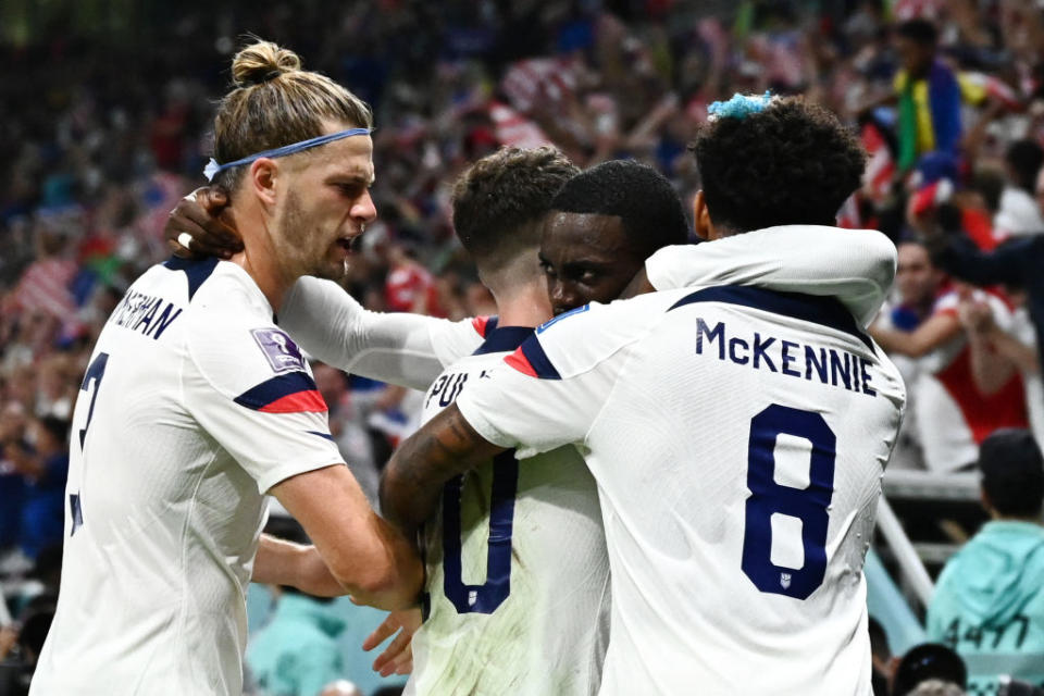 Forward Timothy Weah embraces teammates after scoring the U.S.'s first goal during the Qatar 2022 World Cup in the match against Wales at the Ahmad Bin Ali Stadium, Nov. 21, 2022.<span class="copyright">Jewel Samad—AFP/Getty Images</span>