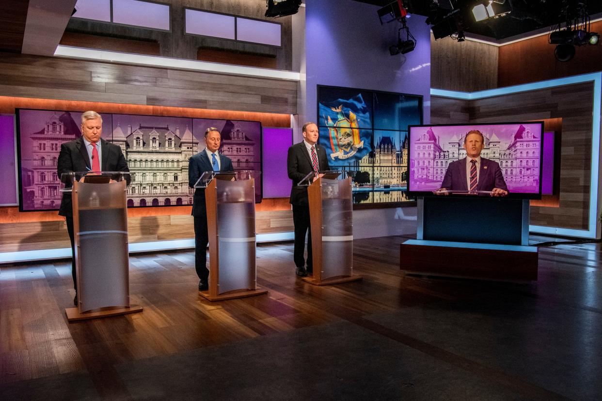 (Left to right) Businessman Harry Wilson, former Westchester County Executive Rob Astorino, Rep. Lee Zeldin, and Andrew Giuliani, son of former New York City Mayor Rudy Giuliani, face off during New York's Republican gubernatorial debate at the studios of Spectrum News NY1 on Monday.