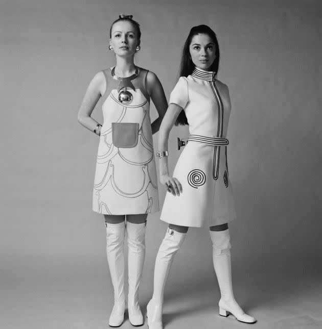 Two U.K. models wear sleeveless short dress with white over the knee go-go boots in January 1970.  (Photo: Evening Standard via Getty Images)