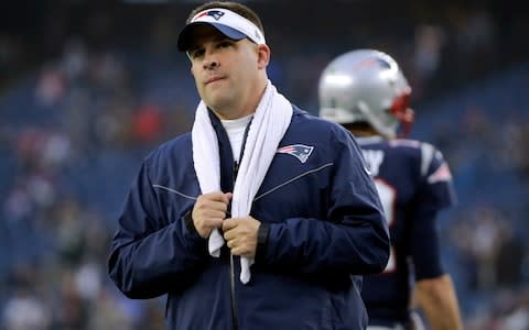 New England Patriots offensive coordinator Josh McDaniels watches his team warm up before an NFL football game against the Minnesota Vikings - Credit: AP