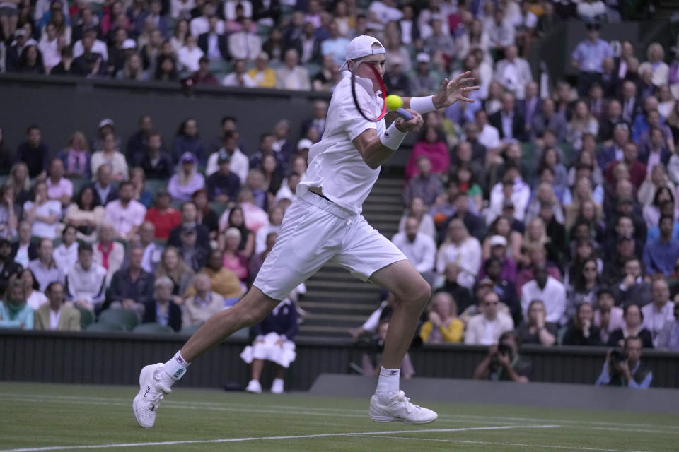 John Isner of the US returns the ball to Britain's Andy Murray during their singles tennis match on day three of the Wimbledon tennis championships in London, Wednesday, June 29, 2022. (AP Photo/Alastair Grant)