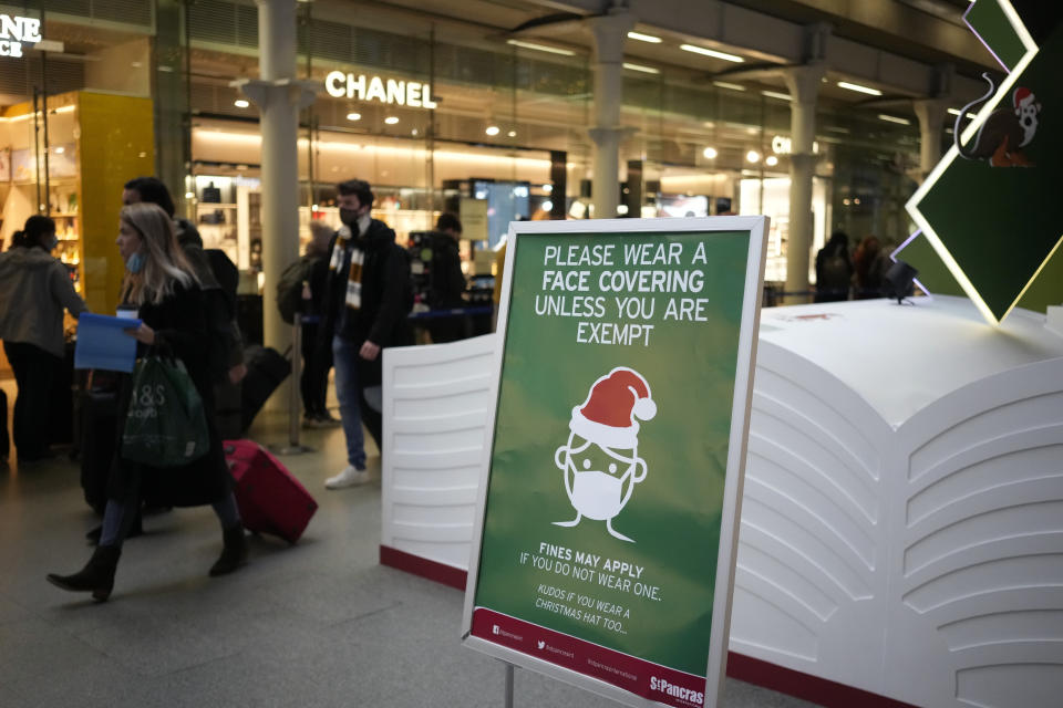 A sign asking people to wear face coverings to curb the spread of coronavirus at London St Pancras International rail station, in London, the Eurostar hub to travel to European countries including France, Friday, Dec. 17, 2021. After the U.K. recorded its highest number of confirmed new COVID-19 infections since the pandemic began, France announced Thursday that it would tighten entry rules for those coming from Britain. Hours later, the country set another record, with a further 88,376 confirmed COVID-19 cases reported Thursday, almost 10,000 more than the day before. (AP Photo/Matt Dunham)