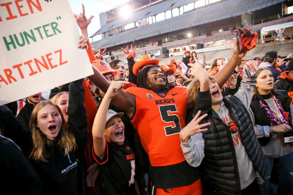 Oregon State running back Deshaun Fenwick (5) celebrates defeating Oregon with fans after the game on Saturday, Nov. 26, 2022 at Reser Stadium in Corvallis, Ore. The final score was 38-34.