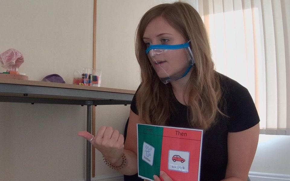 Language therapist Charlotte Gower demonstrating a clear mask