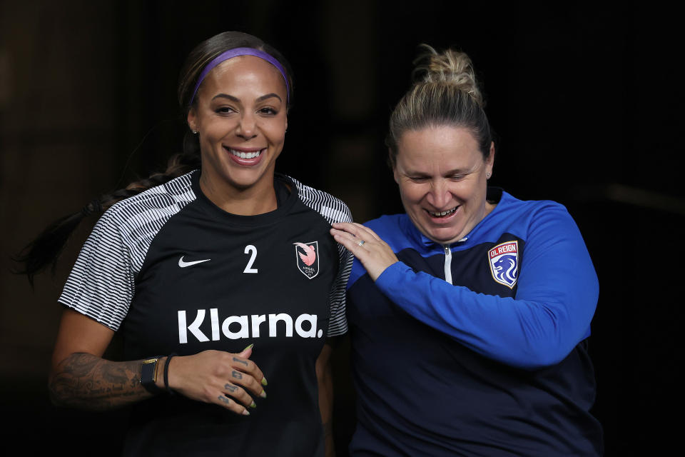 SEATTLE, WASHINGTON - OCTOBER 20: Sydney Leroux #2 of Angel City FC and head coach Laura Harvey of OL Reign walk to the pitch together before the game at Lumen Field on October 20, 2023 in Seattle, Washington. (Photo by Steph Chambers/Getty Images)