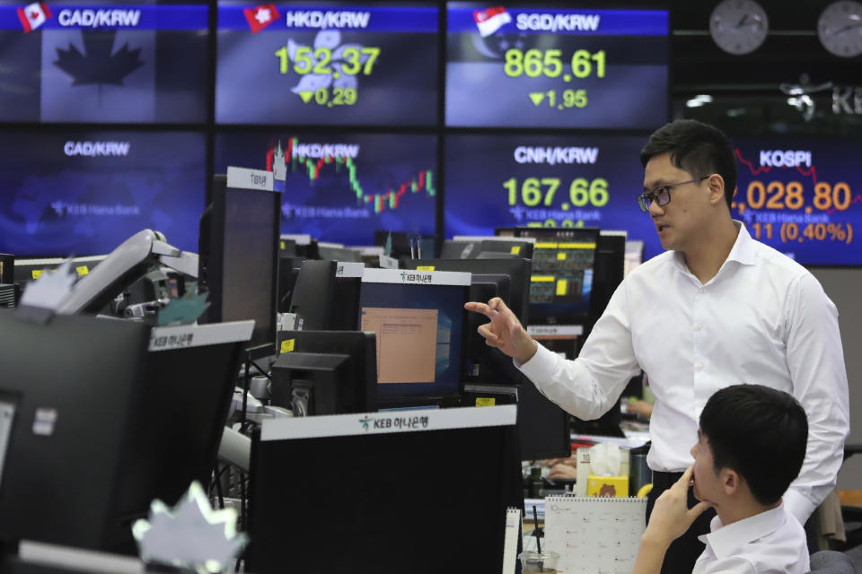 Currency traders work at the foreign exchange dealing room of the KEB Hana Bank headquarters in Seoul, South Korea, Monday, Oct. 7, 2019. Asian shares were mixed Monday, following a healthy report on U.S. jobs, while investors cautiously awaited the upcoming trade talks between the U.S. and China. (AP Photo/Ahn Young-joon)