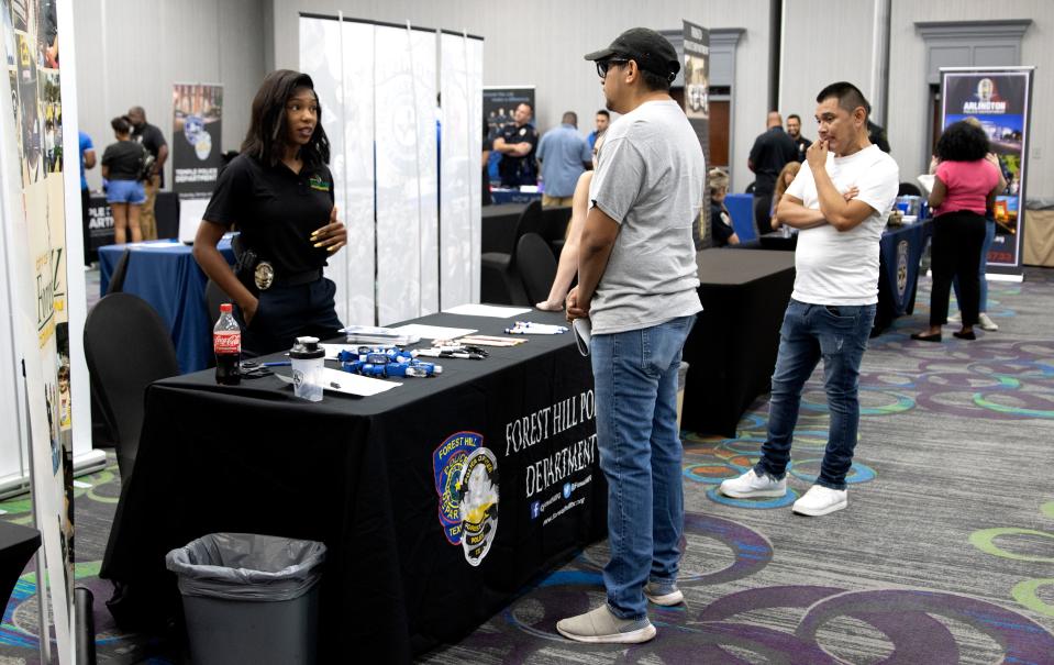 Representatives from 14 law enforcement agencies across Texas, including Arlington, Dallas and Houston, attend a recruiting event in Fort Worth on Friday, July 15, 2022. (Photo by James Doyle Brown, Jr./News21)