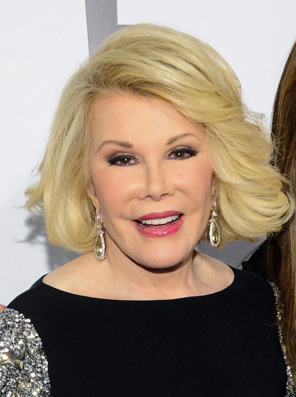 FILE - This April 30, 2012 file photo shows comedian Joan Rivers at the E! Network upfront event at Gotham Hall in New York. When TV personality Joan Rivers thought her New York apartment was haunted some 15 years ago, she called on New Orleans voodoo priestess Sallie Ann Glassman to perform a "spiritual cleansing" of the old brownstone. Glassman tells the Associated Press that the unlikely pair became instant friends during that initial meeting, where Glassman wore a flowing white gown as she chased off disturbing spirits in the building. Next month, Rivers is heading to New Orleans to return the favor. The sharp-tongued comedian will be hosting two standup talk shows benefiting Glassman's New Orleans Healing Center _ a more than 50,000 square foot building housing some two dozen businesses and organizations focused on what Glassman describes as the "environmental, spiritual, economic, cultural, emotional and physical healing of New Orleans" following Hurricane Katrina in 2005. (AP Photo/Evan Agostini, file)