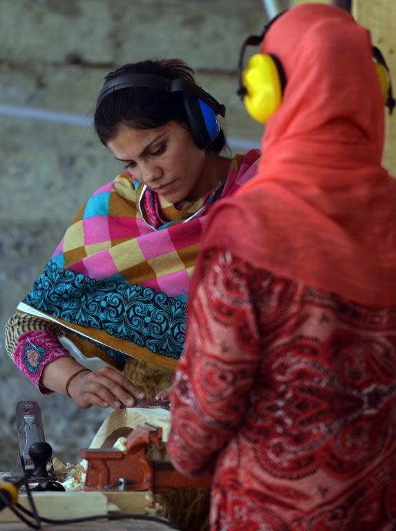 Local carpenters work at their woodshop in Altit village, in Pakistan's northern Hunza valley, on August 6, 2014