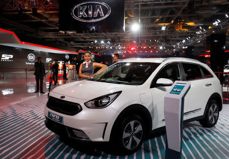 A model poses alongside Kia Niro, a hybrid car, at the India Auto Show 2018 in Greater Noida, India, February 7, 2018. REUTERS/Saumya Khandelwal