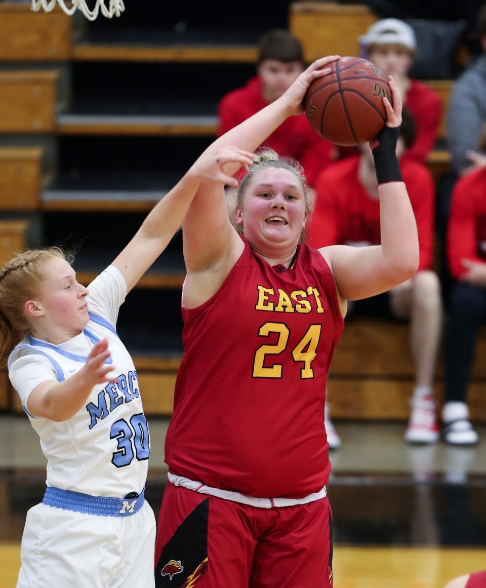 Bullitt East's Gracie Merkle (24) grabs a rebound over Mercy's Gracie Helm (30) during the Girls 24th District Final at the Fern Creek High School in Louisville, Ky. on Feb. 23, 2022.  Bullitt East won 60-55.