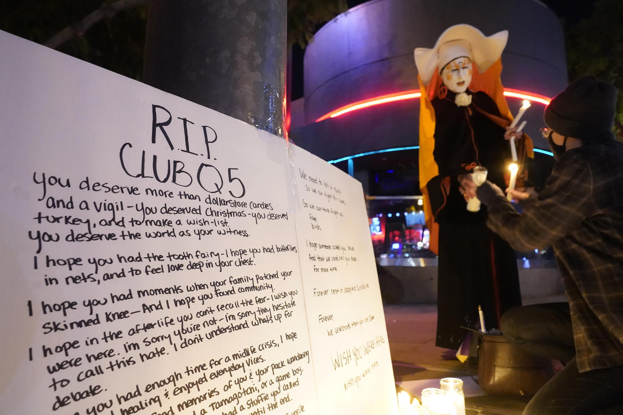 Sister Unity lights candles at a memorial for the victims of Club Q in Colorado Springs, Colo., outside Rocco's WeHo in West Hollywood, Calif., Sunday, Nov. 20, 2022. (AP Photo/Damian Dovarganes)