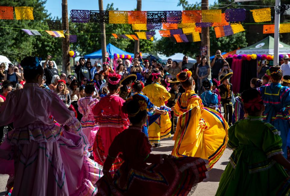 Ballet folklorico dancers perform together for the audience during the Día de los Muertos Festival at Desert Memorial Park cemetery in Cathedral City, Calif., Saturday, Oct. 28, 2023.