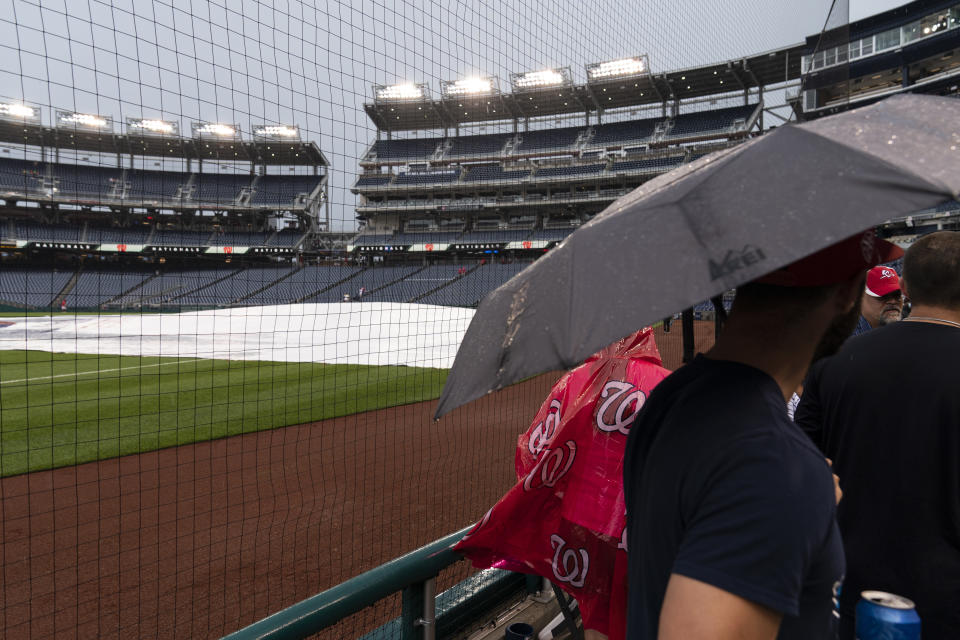 Fans gather to leave a postponed baseball game between the Washington Nationals and the San Francisco Giants at Nationals Park, Thursday, June 10, 2021, in Washington. The game was postponed until Saturday June 12th. (AP Photo/Alex Brandon)