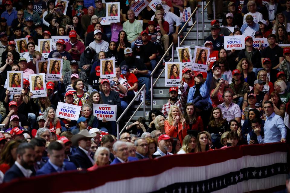 Supporters of former President Donald Trump hold up the image of Laken Riley, a University of Georgia student who was murdered in February, at a campaign event over the weekend in Georgia.
