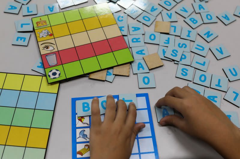 Children make words during a class of the 'Project to Strengthen Learning' with the aim of making up for the shortfall aggravated by the pandemic, in Sao Paulo