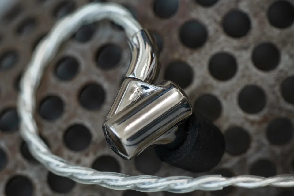 A close up picture of an ONI in-ear monitor made by Singularity.