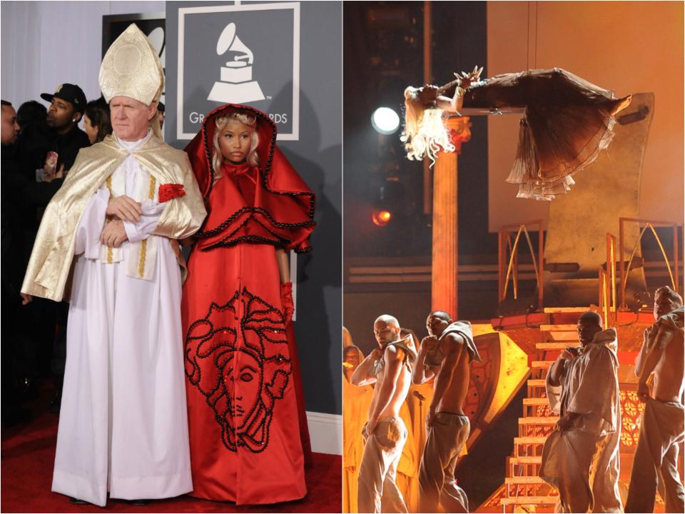 A man dressed in a traditional bishop uniform with a large hat escorting Nicki in a dramatic silk hooded dress with a large Versace medusa logo on it. In another photo she is suspended in the air by wires laying horizontally in a flowing dress above dancers.