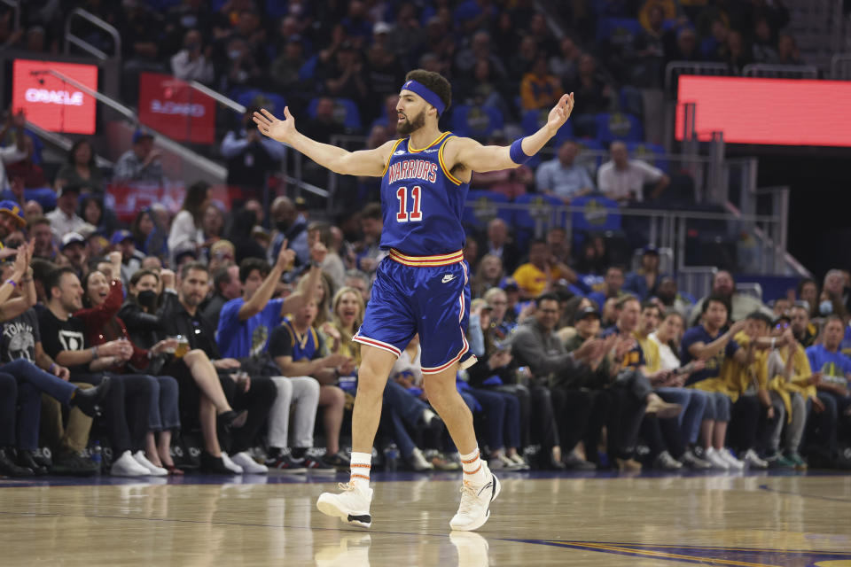 Golden State Warriors guard Klay Thompson celebrates after scoring against the Utah Jazz during the first half of an NBA basketball game in San Francisco, Saturday, April 2, 2022. (AP Photo/Jed Jacobsohn)