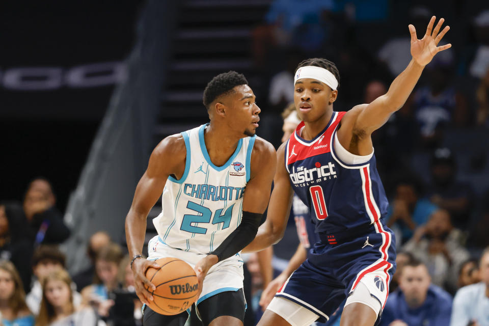 Charlotte Hornets forward Brandon Miller (24) looks to pass against Washington Wizards guard Bilal Coulibaly (0) during the first half of an NBA basketball game in Charlotte, N.C., Wednesday, Nov. 8, 2023. (AP Photo/Nell Redmond)