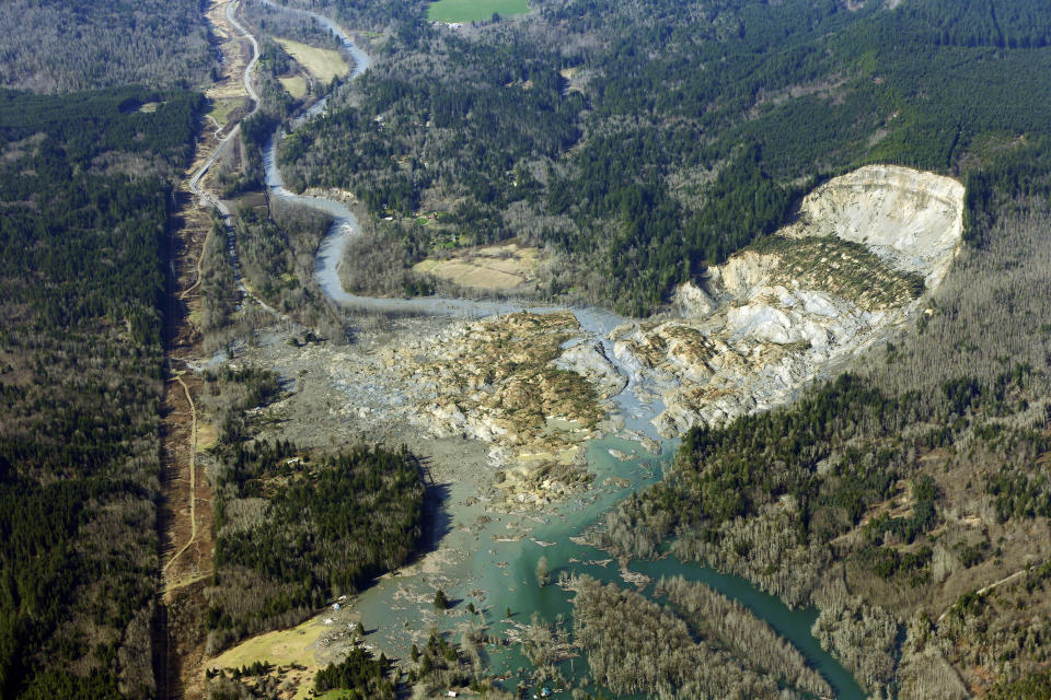 FILE - The massive mudslide that killed 43 people in the community of Oso, Wash., is viewed from the air on March 24, 2014. (AP Photo/Ted S. Warren, File)
