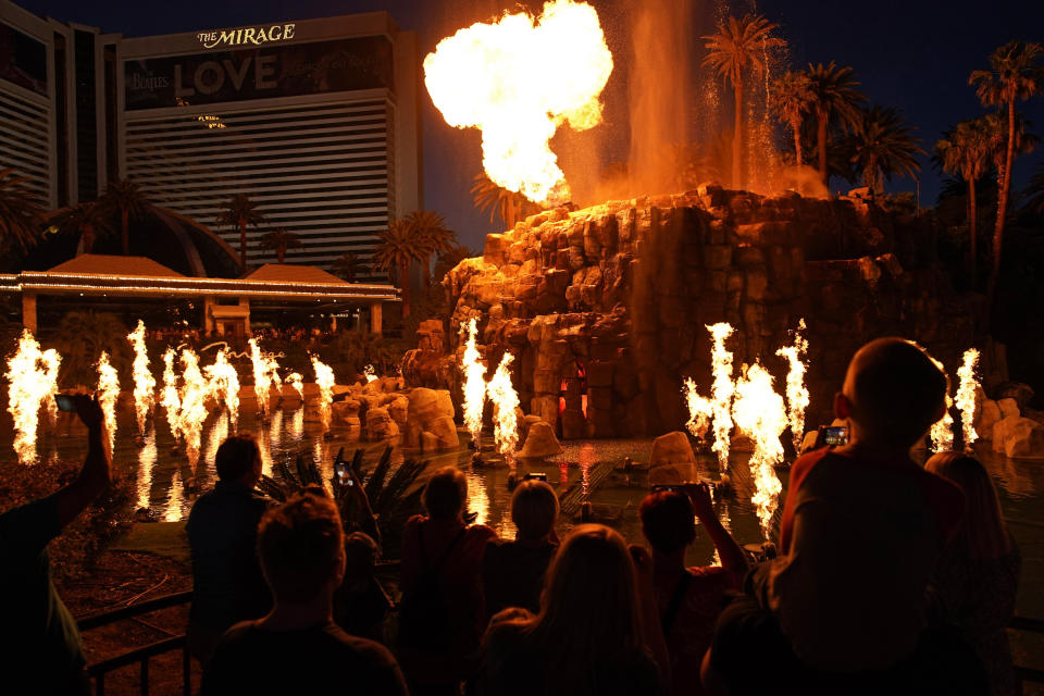 FILE - People watch the Volcano show at the Mirage hotel-casino along the Las Vegas Strip, May 13, 2022, in Las Vegas. The iconic Mirage hotel-casino on the Las Vegas Strip will shut its doors this summer on July 17, 2024, the end of an era for a property credited with helping transform Sin City into an ultra-luxury resort destination. (AP Photo/John Locher, File)