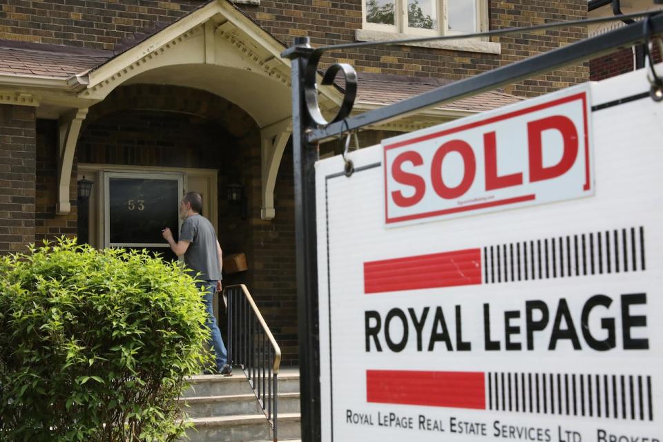 A realtor's for sale sign stands outside a house that had been sold in Toronto, Ontario, Canada May 20, 2021.